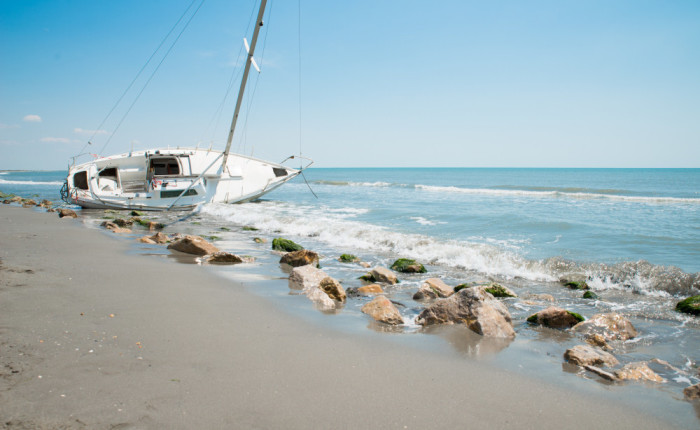 sailboat wrecked and stranded on beach