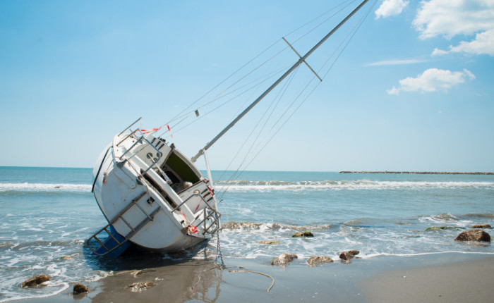sailboat wrecked and stranded on beach